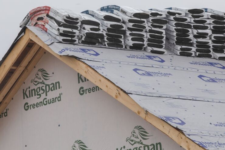 Roofing tile packs on the roof of a home under construction