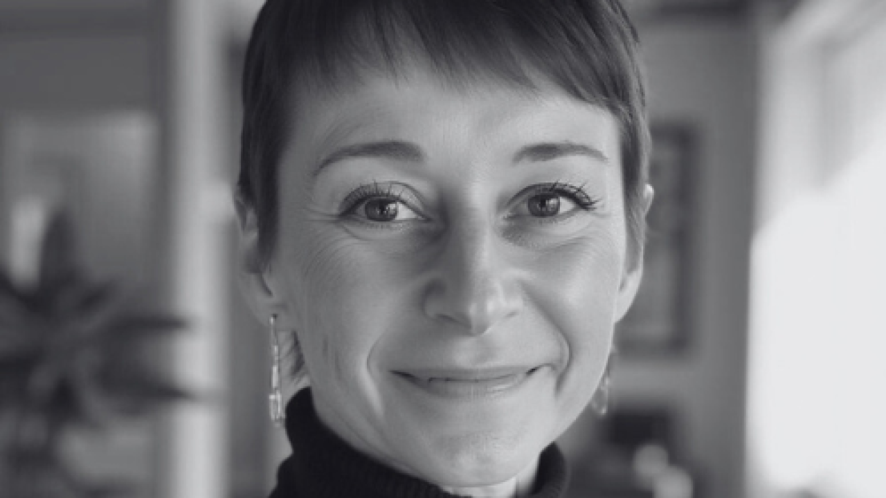 A woman smiling for a portrait photo.