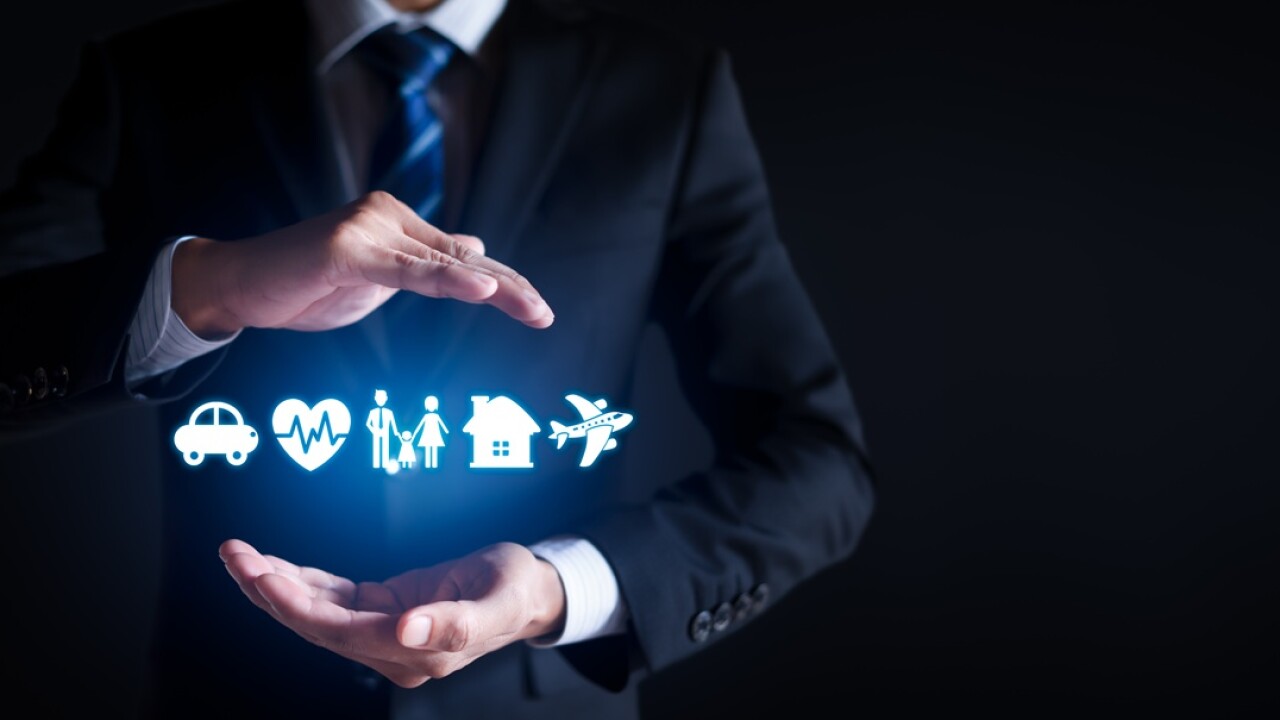 Icons of a car, heartbeat, people, a house and an airplane between a man's hands.