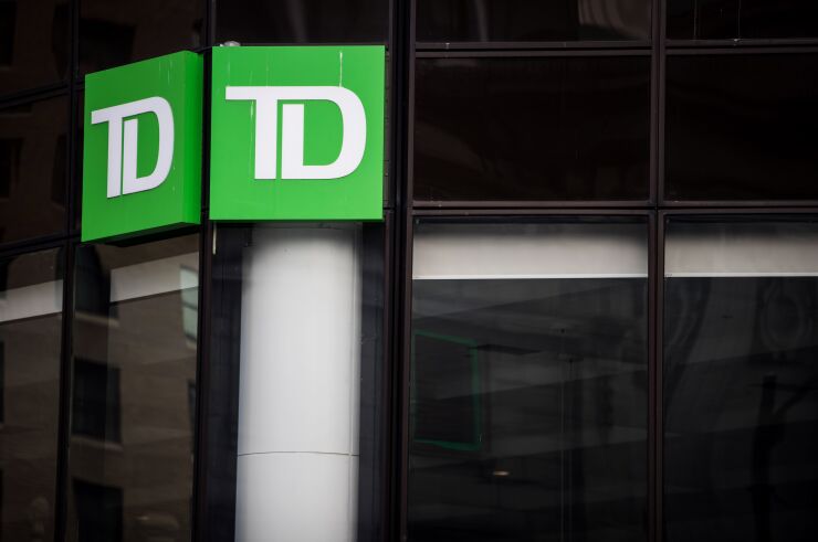 Signage is displayed outside a Toronto-Dominion bank branch in Vancouver.