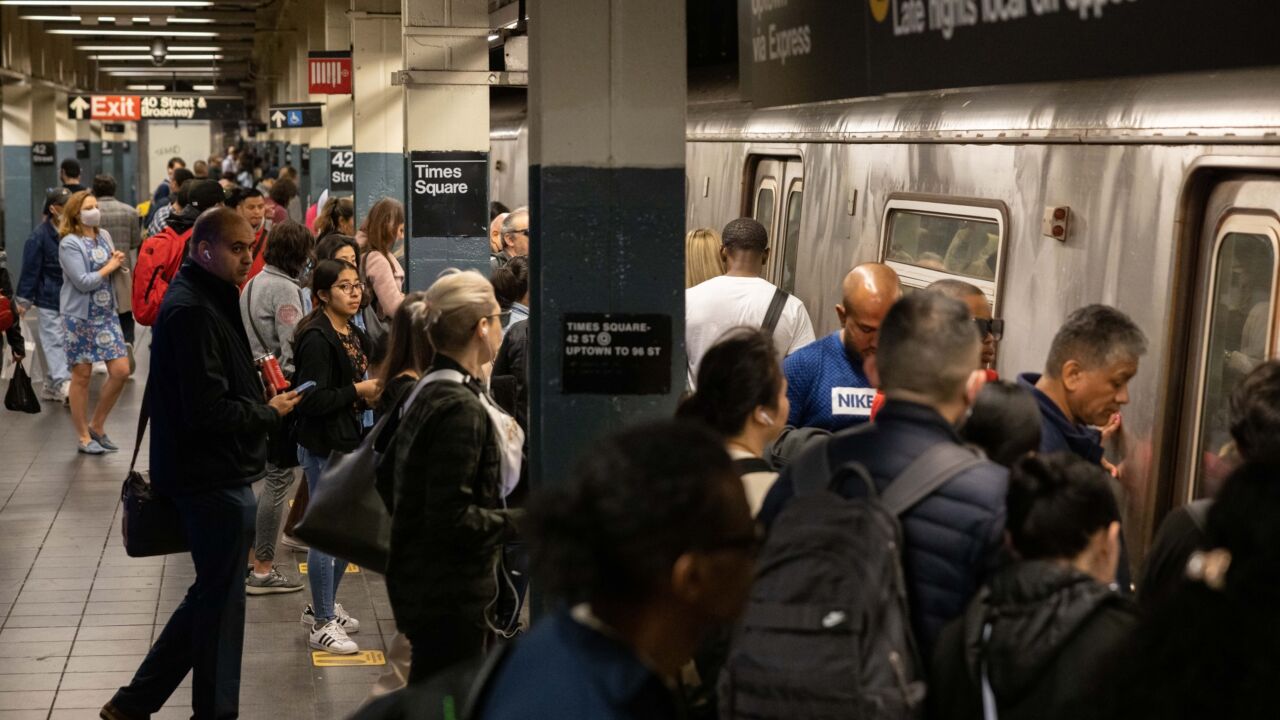Passengers board a New York Subway train