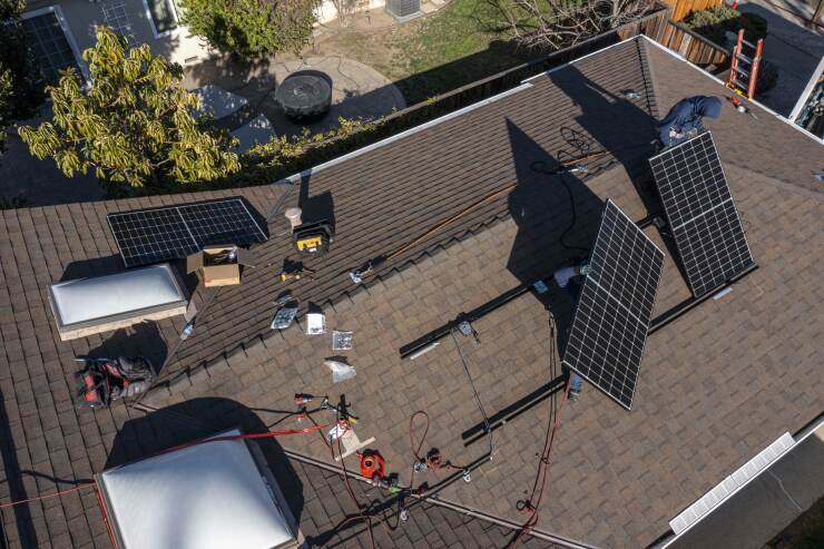 Contractors install SunRun solar panels on the roof of a home in San Jose, California.