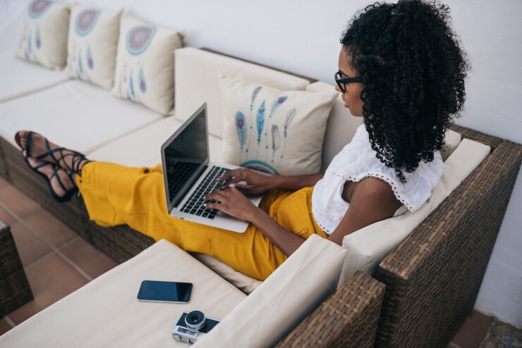 Black woman working on a laptop