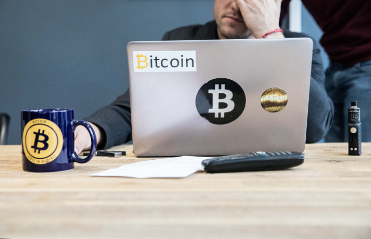 Bitcoin trader takes a moment from a busy day at his desk.