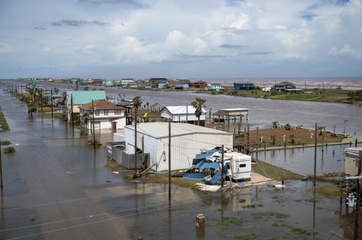 Structures surrounded by flood water.