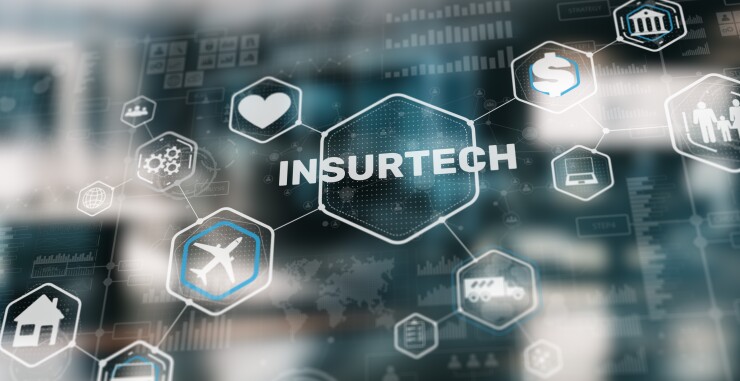 A holographic image that reads insurtech surrounded by other icons.