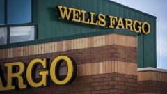 Signage is displayed outside a Wells Fargo & Co. bank branch in Palatine, Illinois, U.S., on Tuesday, July 10, 2018. Wells Fargo & Co. is scheduled to release earnings figures on July 13.