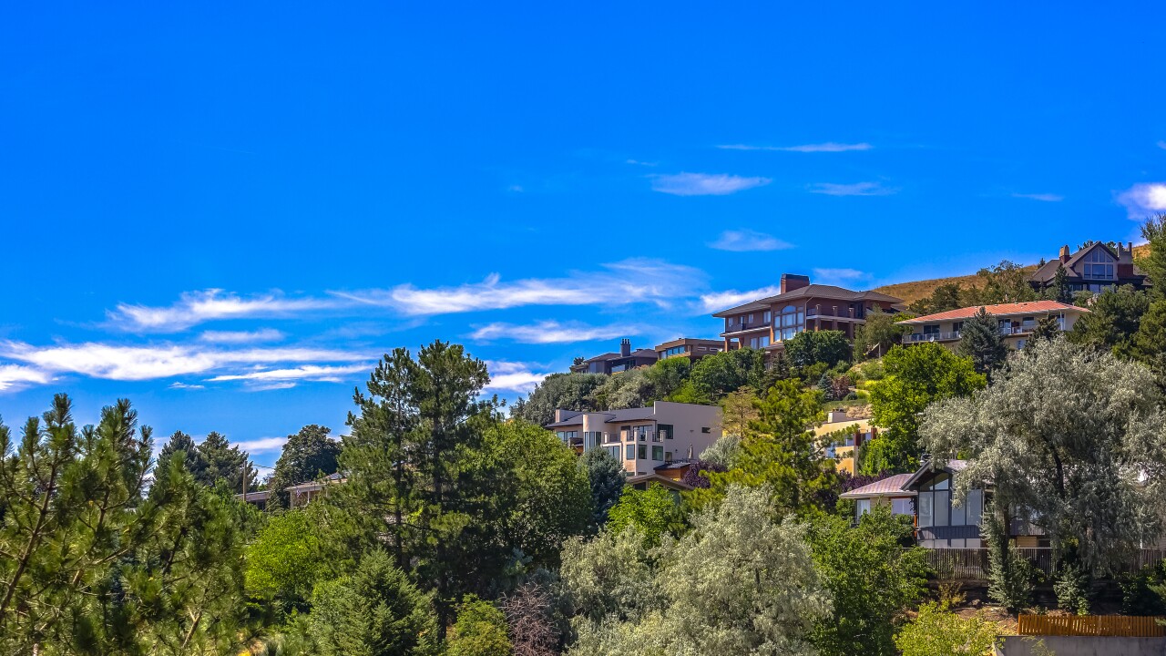 Homes on hill under blue sky in Salt Lake City
