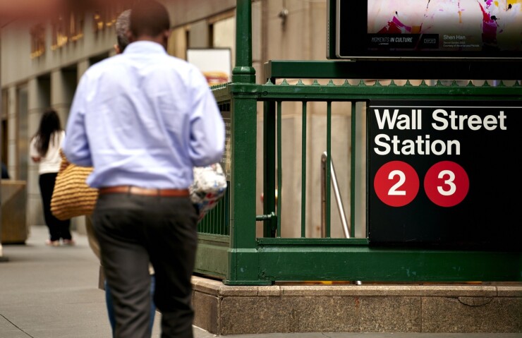 A rider makes his way to the Wall Street subway station near the New York Stock Exchange.