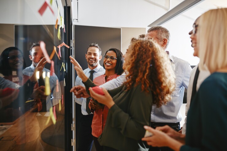 Groupd of employees working together, brainstorming in office