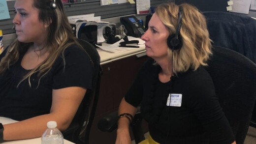 SpringFour CEO Rochelle Gorey wearing headphones at BMO contact center