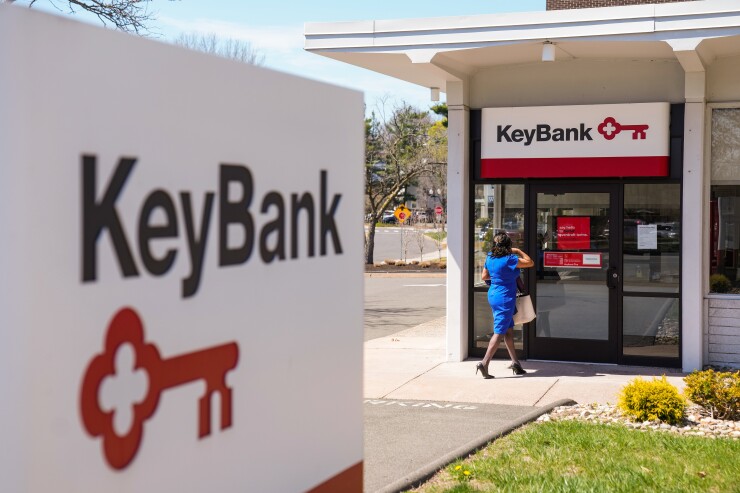 Key Bank branch with sign and woman walking towards the entrance