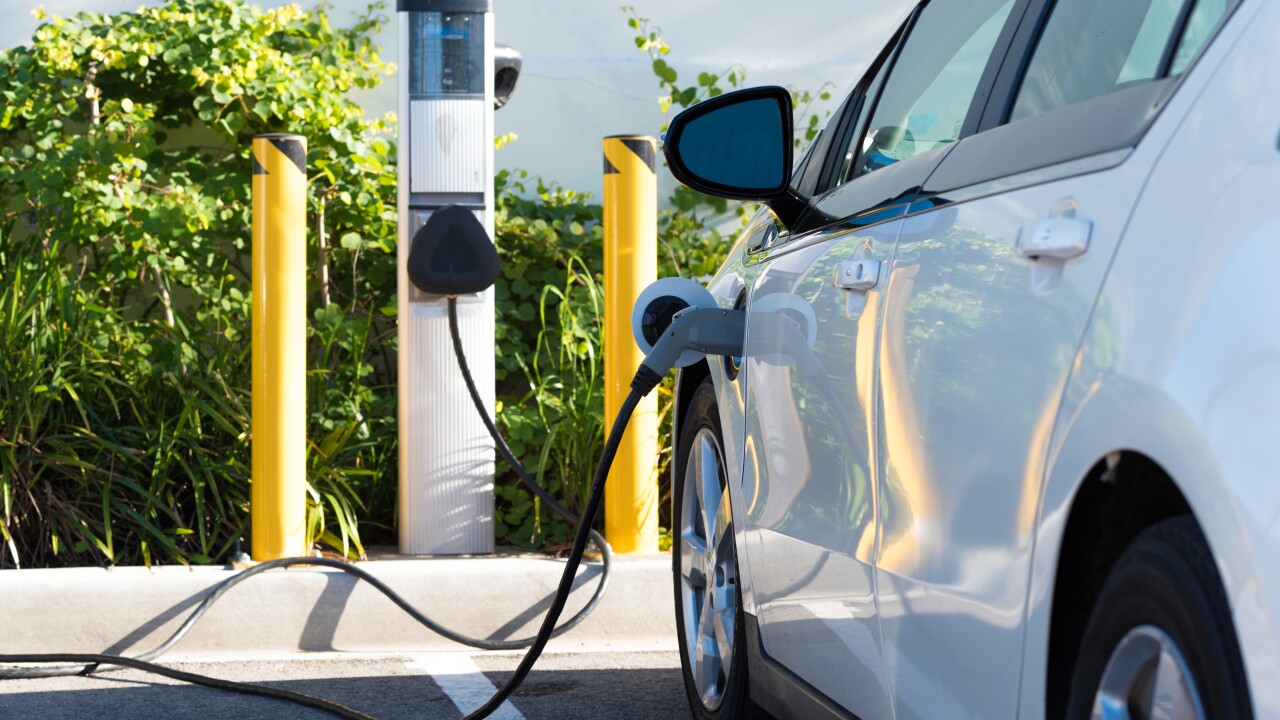 A car parked at an electric charging unit