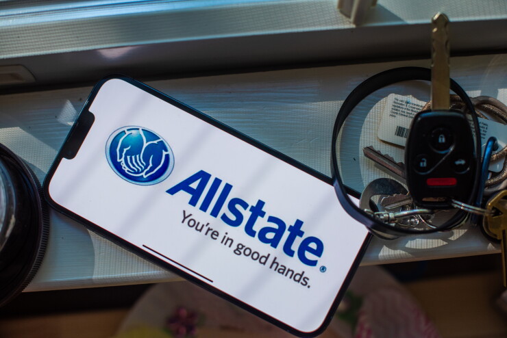 Allstate logo on a phone screen next to keys.