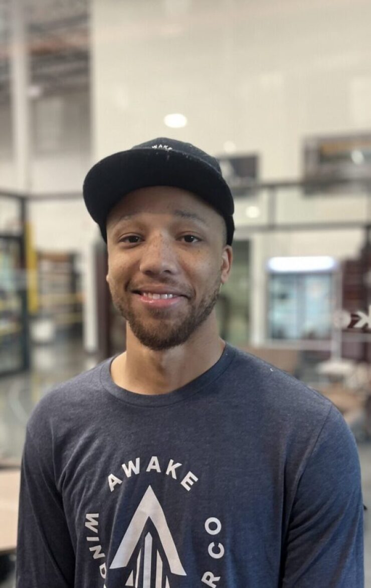 A man in a baseball hat posing for a photo.