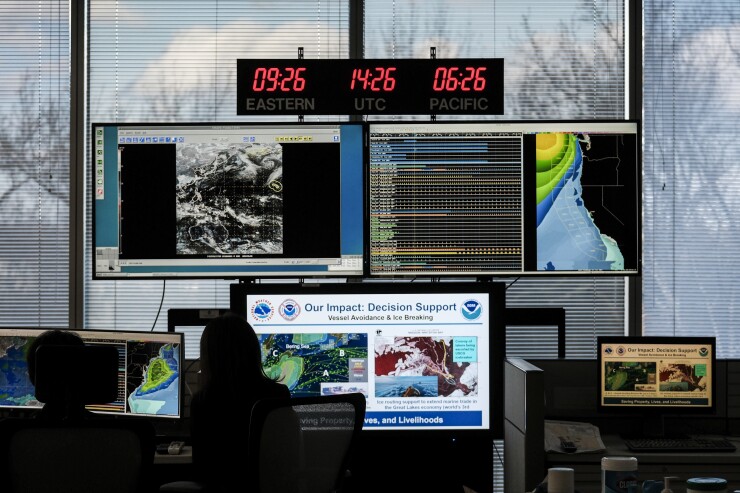 Workers in front of monitors at the NOAA Center for Weather and Climate Prediction headquarters in College Park, Maryland in December 2024.