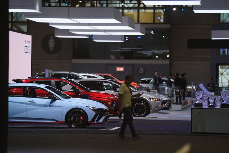 An attendee walks past a row of Hyundai cars at the 2024 New York International Auto Show