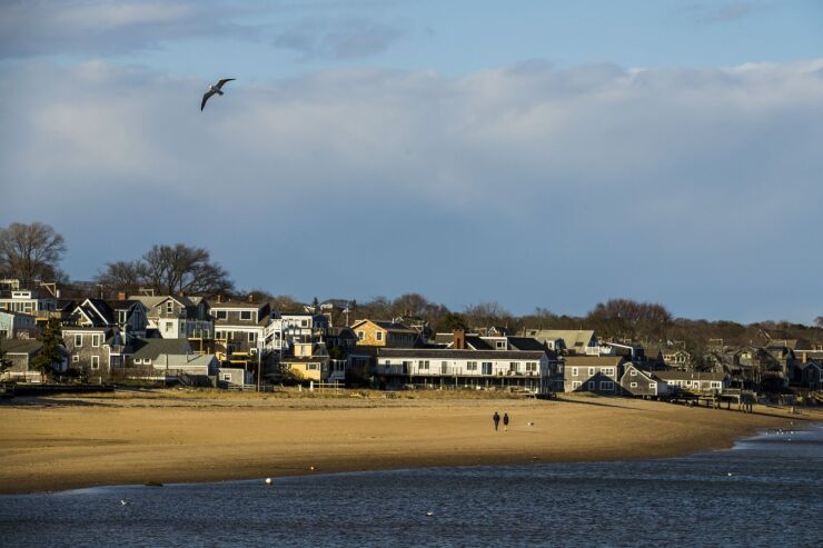 People walk along the beach in Cape Cod, Massachusetts
