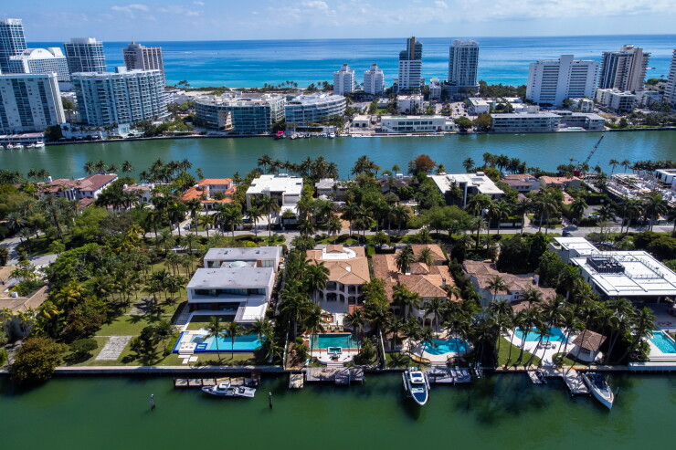 An aerial view of several houses on the water in Florida.