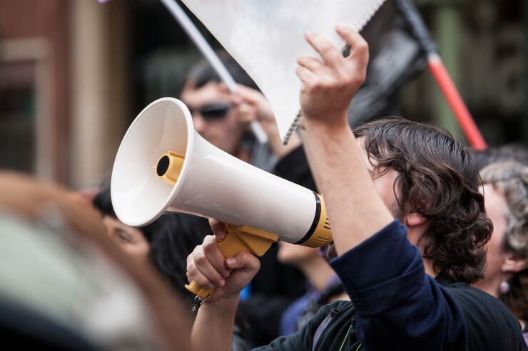 demostrator with megaphone and notebook protesting