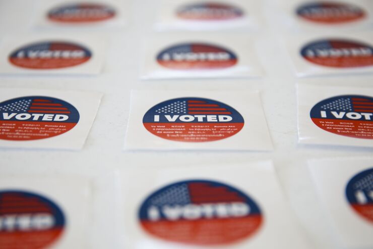 "I Voted" stickers at an early voting polling location at Dockweiler Beach for the 2020 Presidential election in Los Angeles, California, U.S., on Thursday, Oct. 29, 2020. With eight days until the election, 59.4 million people have cast ballots in-person at early voting centers or by mail, according to the U.S. Elections Project. Photographer: Patrick T. Fallon/Bloomberg