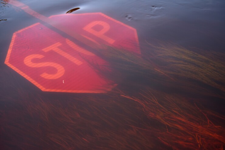 A stop sign lays submerged in floodwaters after Hurricane Florence hit in Beulaville, North Carolina, U.S., on Wednesday, Sept. 19, 2018.