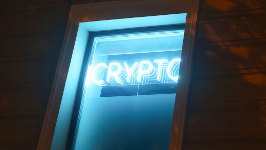 A neon sign reading "Crypto" and a euro currency symbol at a cryptocurrency exchange bureau in Riga, Latvia