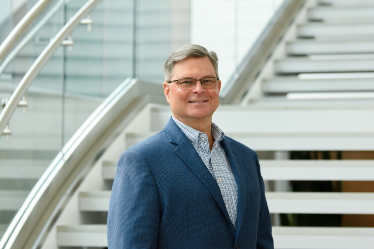 Robert Stephens of CFO Navigator and Mauldin & Jenkins posing in front of a staircase