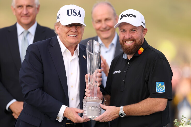 President Donald Trump, left, and Shane Lowry of Ireland pose with the trophy at the Irish Open in Doonbeg.