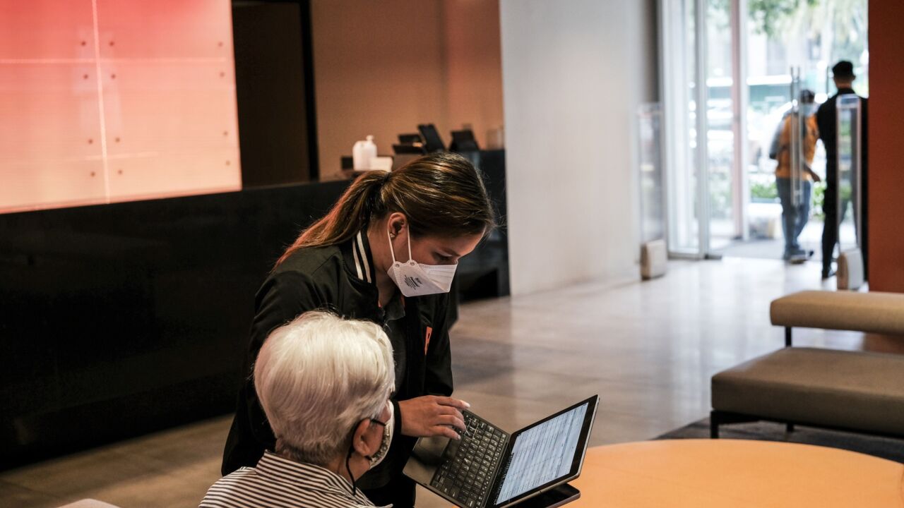 An employee attends to a customer inside a Union Bank of the Philippines paperless branch called The Ark in Makati City, the Philippines, on Tuesday, April 19, 2022. Union Bank offers a wide range of financial and related products and services, with its core business being corporate finance and consumer finance. Photographer: Veejay Villafranca/Bloomberg