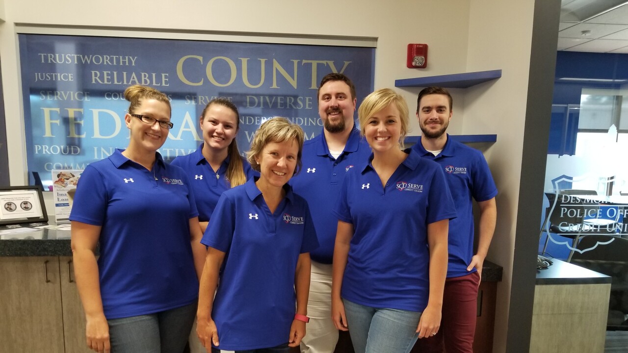 The staff of Serve Credit Union in Des Moines, Iowa, shows off their new gear after the CU changed its name this week.