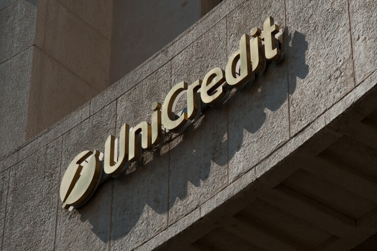 The UniCredit logo hangs above a bank branch in Milan, Italy.