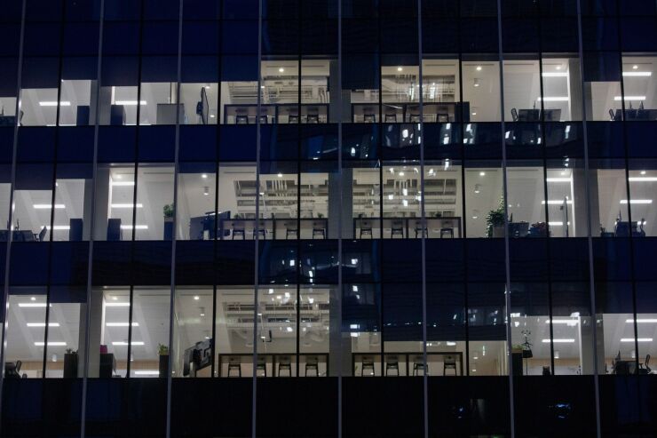 Lights illuminate office floors in the Societe Generale SA building in the Canary Wharf business, financial and shopping district of London, U.K., on Monday, Sept. 14, 2020. Londoners are steadily increasing their use of public transport after schools reopened, freeing parents to go back to the workplace. Photographer: Simon Dawson/Bloomberg