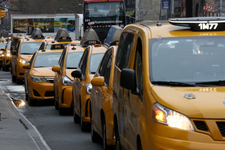 Taxis wait to pick up commuters outside Pennsylvania Station in New York.