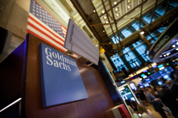 Goldman Sachs signage is displayed at the company's booth on the floor of the New York Stock Exchange.