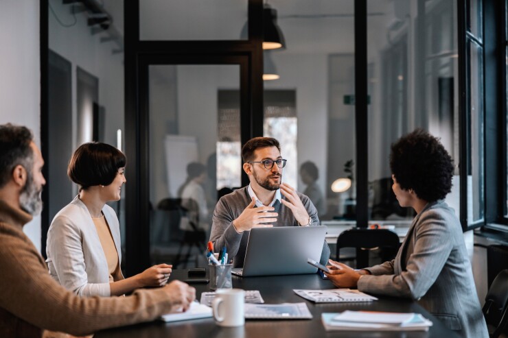 Group of employees sitting at table