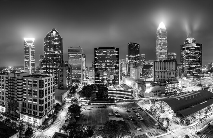 Aerial view of Charlotte skyline on a foggy night.