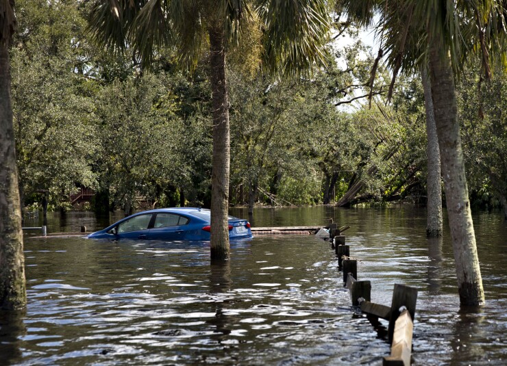 A car sits submerged in flood waters along a road in Buckingham, Florida, U.S., on Tuesday, Sept. 12, 2017