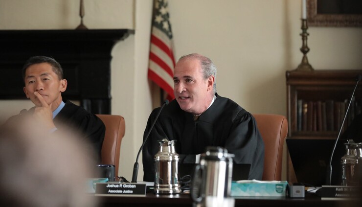California Supreme Court Associate Justice Joshua Groban, center, and Associate Justice Goodwin Liu to his left.