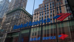 Buildings are seen reflected on the exterior of a Bank of America branch in New York.