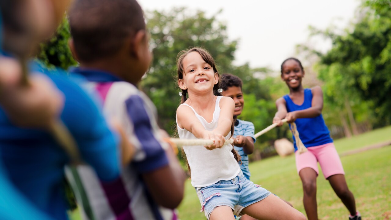 Girl playing tug of war at summer camp