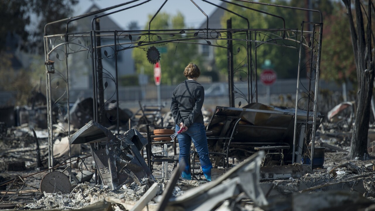 Resident views personal items burned by wildfires in Santa Rosa, California, U.S., on Thursday, Oct. 12, 2017.