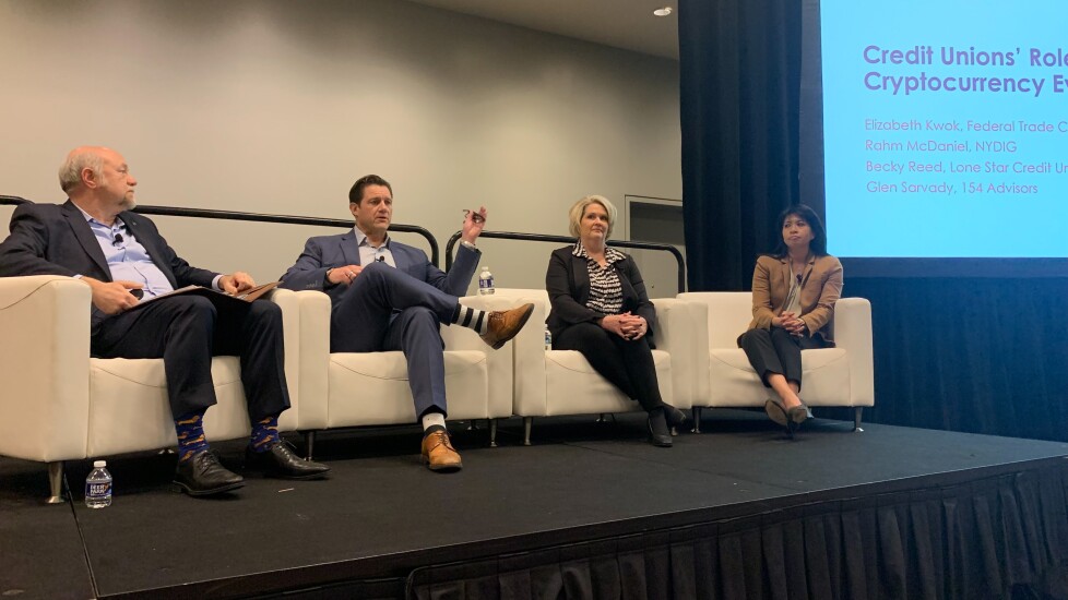 A panel of speakers in white leather chairs during a session at the Credit Union National Association's Governmental Affairs Conference in 2023,