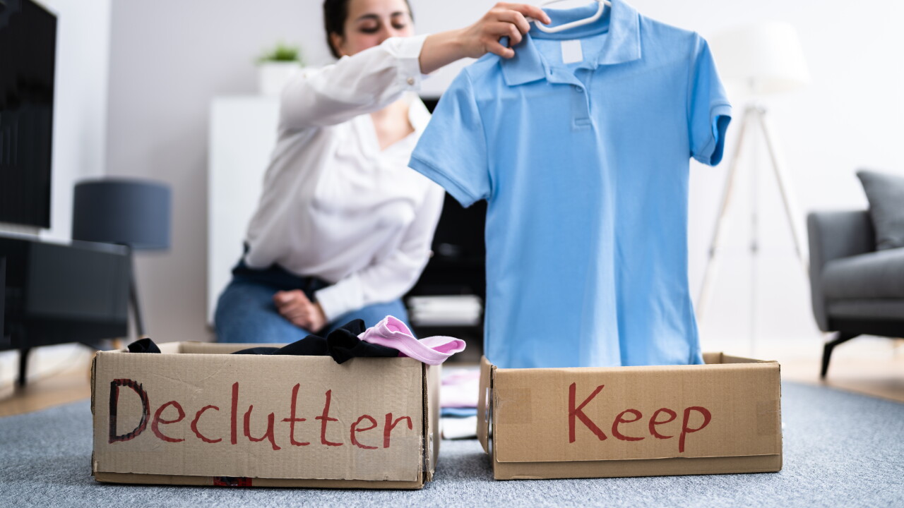 Woman Decluttering Clothes, Sorting and Cleaning Up
