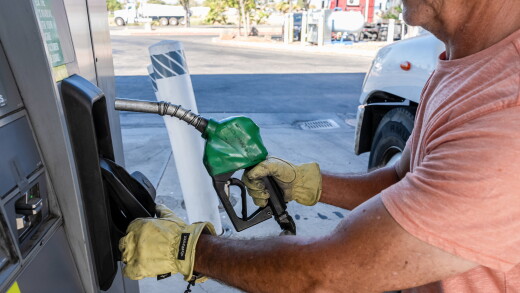 A driver returns a fuel nozzle after refueling a tractor trailer with diesel fuel at a Chevron truck stop in Tracy, California.