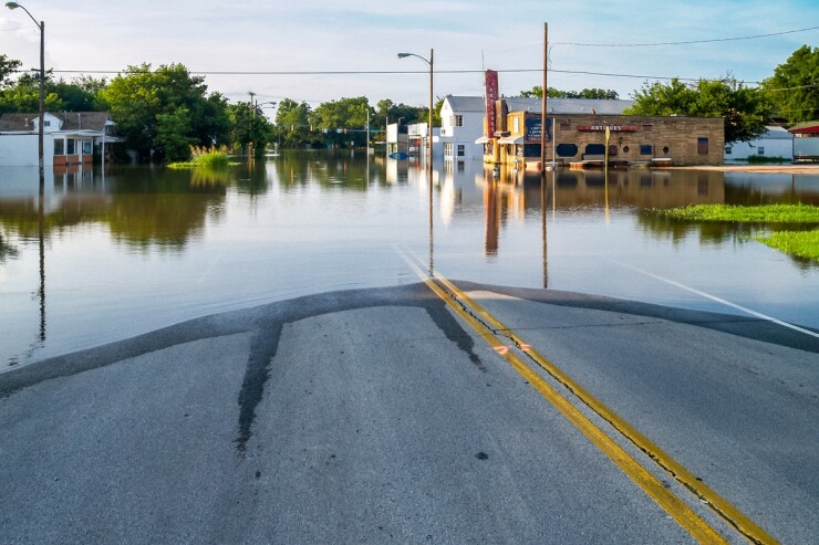 Panoramic view of a flooded town street.
