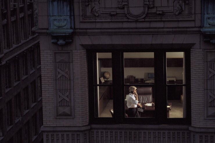 View through window of businessman on phone