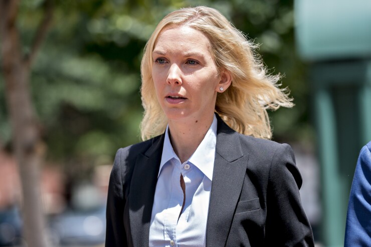 Heather Washkuhn, manager of Paul Manafort's personal and business finances, walks toward District Court in Alexandria, Virginia.
