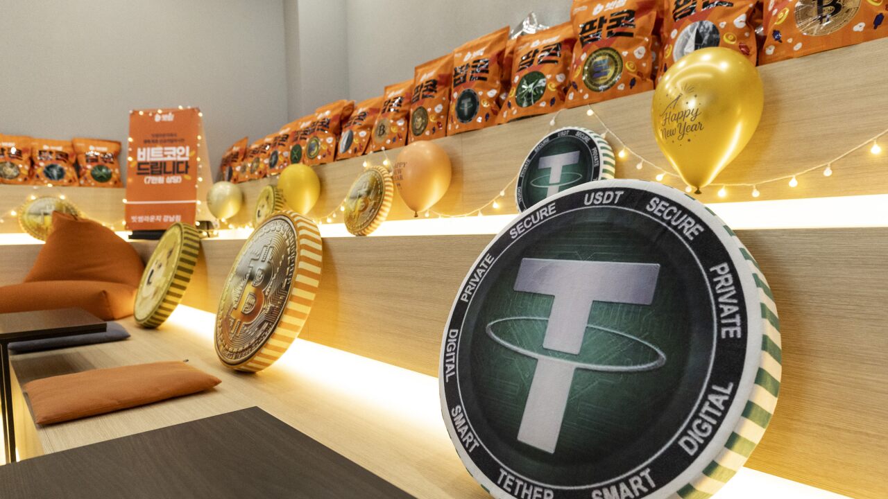 A picture of the tether logo on a cushion in an office.