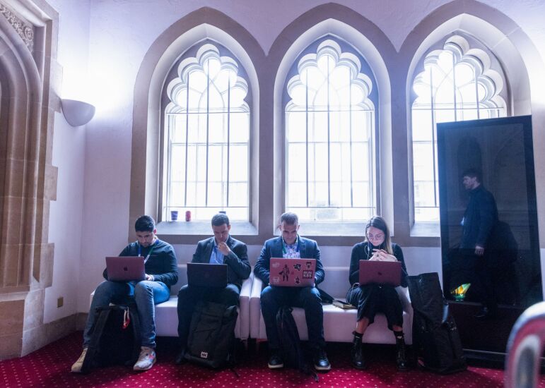 Attendees work on laptop computers at the IFGS 2022 summit at the Guildhall in London, U.K., on Monday, April 4, 2022. Innovate Finance's Global Summit -- part of U.K. Fintech Week -- aims to showcase Britain's financial technology sector and its global ambitions. Photographer: Chris Ratcliffe/Bloomberg